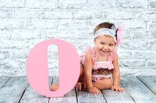 Beautiful And Cute Girl In A Pink Dress With The Letter O. Emotional Girl. Stock Photography