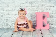 Beautiful And Cute Girl In Pink Dress With The Letter E. Emotional Girl. Royalty Free Stock Images