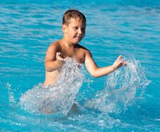 Boy Swims With A Splash In The Water Park Stock Images