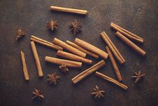 Cinnamon Sticks And Anise Stars On The Brown Rusty Backround. Stock Photos