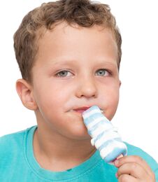 Boy Eating Ice Cream On A White Background Royalty Free Stock Photos