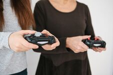 A Young Girl And An Elderly Woman Play Together In A Video Game. Joint Pastime. Family Life. Communication Of The Royalty Free Stock Image A Young Girl And An Elderly Woman Play Together In A Video Game. Joint Pastime. Family Life. Communication Of The Royalty Free Stock Image