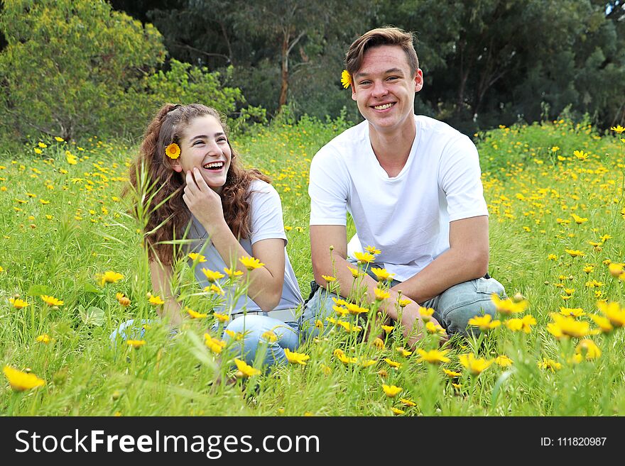 A Teenage Young Couple Walking In A Field Of Chrysanthemum