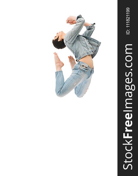 Brunette with shot haircut in jeanswear jumping gracefully isolated shot on white background. Brunette with shot haircut in jeanswear jumping gracefully isolated shot on white background