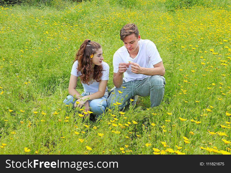 A teenage young couple having fun in a field of chrysanthemum