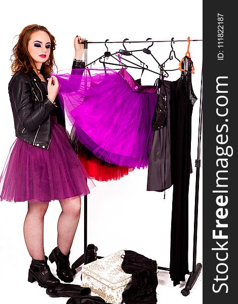 Beautiful girl in the style of rock, fashion make-up and hairstyle chooses a tulle skirt