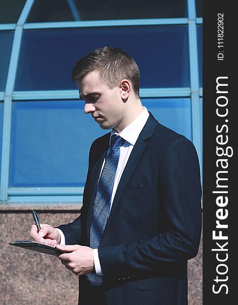 Thoughtful businessman standing in the lobby of a spacious office.