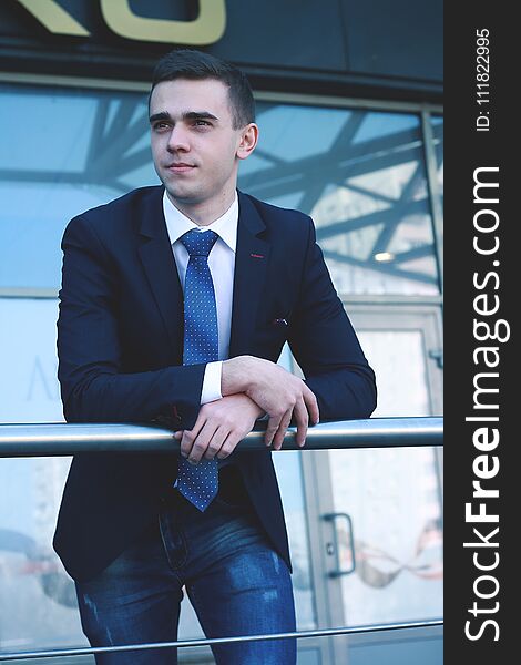 Close up.young businessman standing on balcony in office.