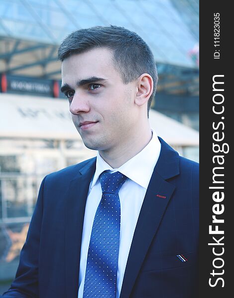 Close up.young businessman on background of office building.