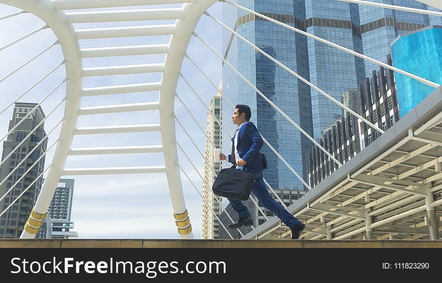 a business man run with laptop briefcase at pedestrian