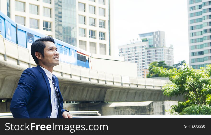 Business man stand with feeling confident and freedom at outdoor