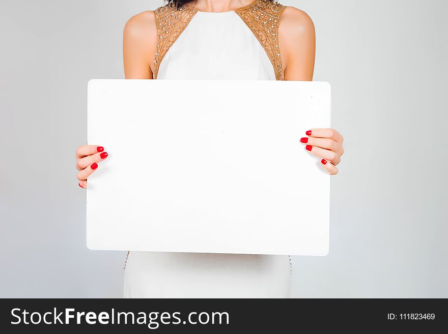 Photo of a sheet of white paper, a card in beautiful female hands