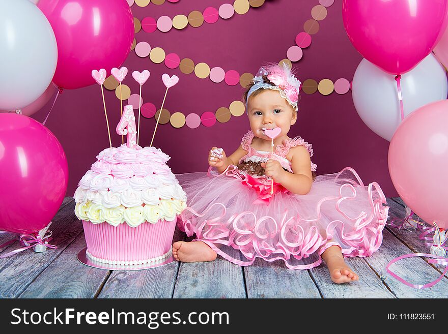 Portrait Of A Little Cheerful Birthday Girl With The First Cake. Eating The First Cake. Smash Cake