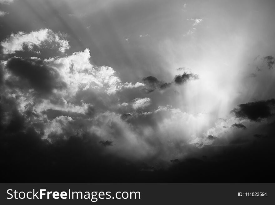 Sun rays and clouds in the evening sky. Black and white image. Sun rays and clouds in the evening sky. Black and white image.