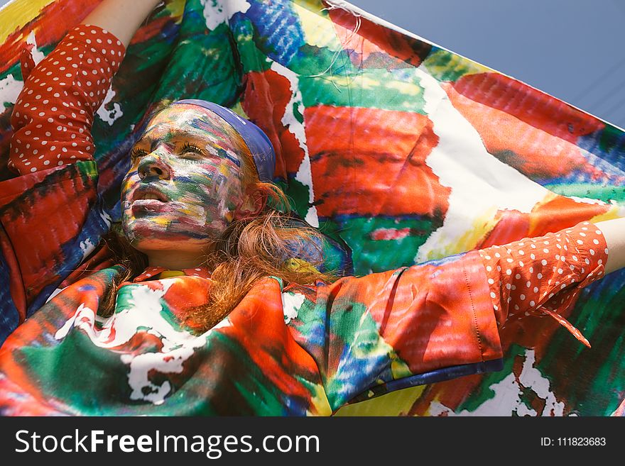 Woman With Face Paint Raising Her Hands Holding Textile