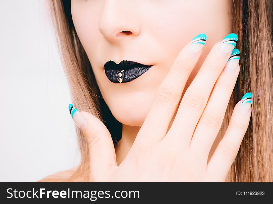 Woman With Black Lipstick and Teal Nail Polish