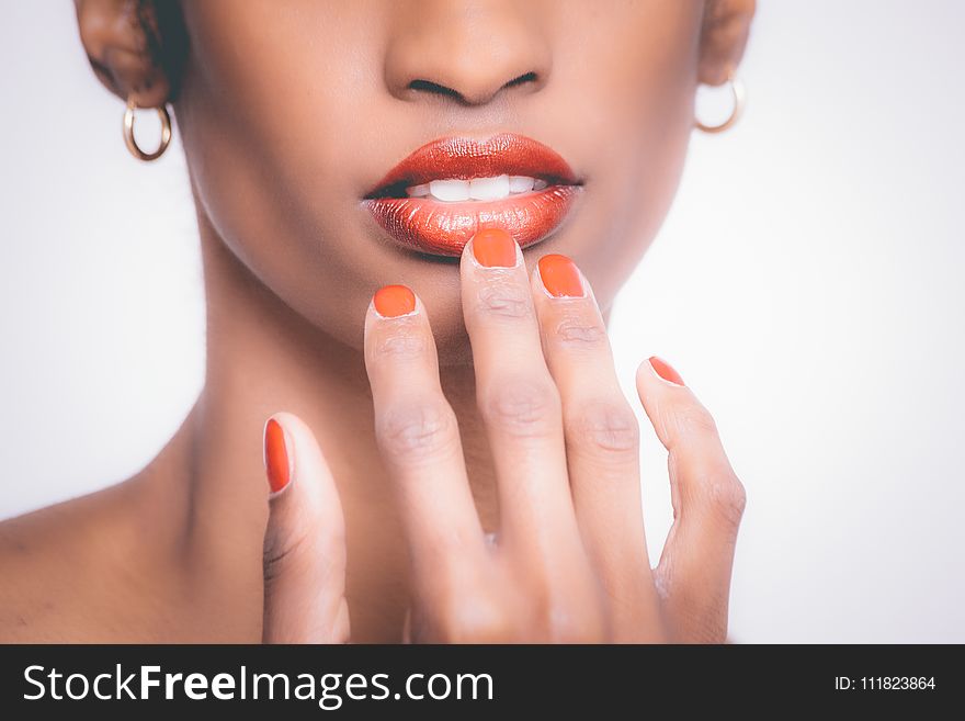Woman With Orange Manicure