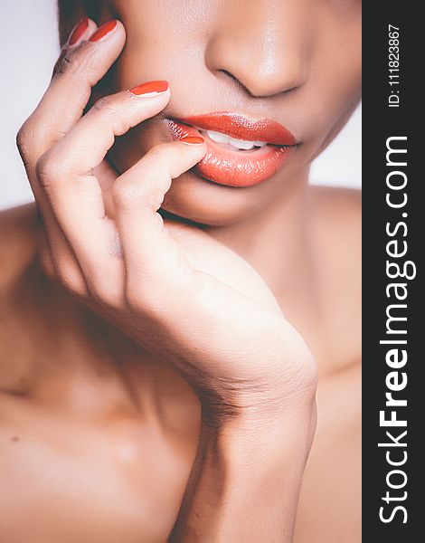 Woman With Orange Lipstick and Manicure Taking Selfie