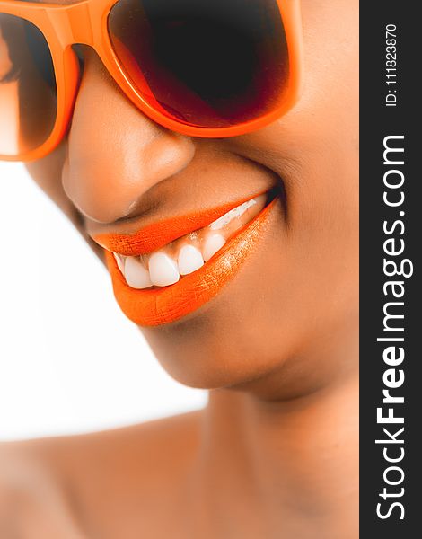 Woman Wearing Orange Frame Sunglasses and Orange Lipstick