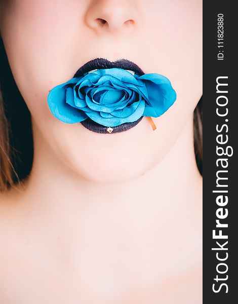 Woman Wearing Black Lipstick With Blue Rose on Mouth