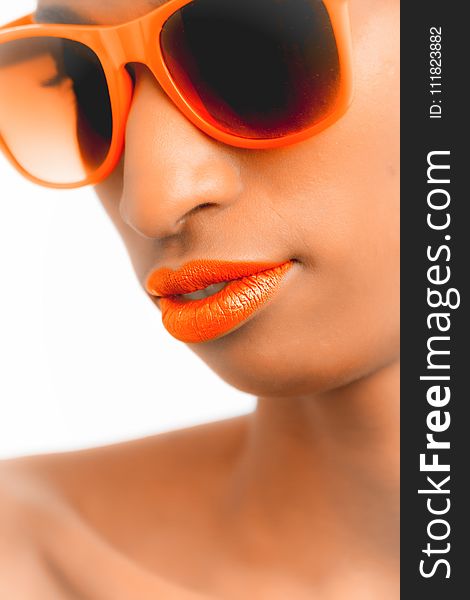 Closeup and Selective Focus Photograph of Woman Wearing Orange-framed Wayfarer-style Sunglasses