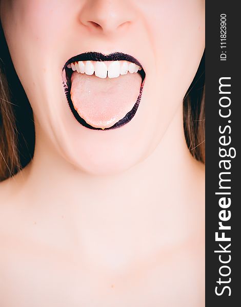 Woman Wearing Black Lipstick Tongue Out Photo