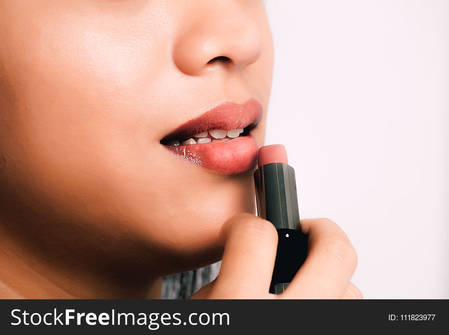 Woman Using Pink Lipstick