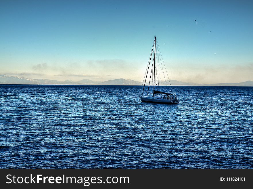 White Sailing Boat On Bodies Of Water