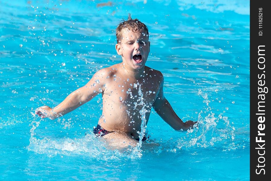 Boy Swims With A Splash In The Water Park