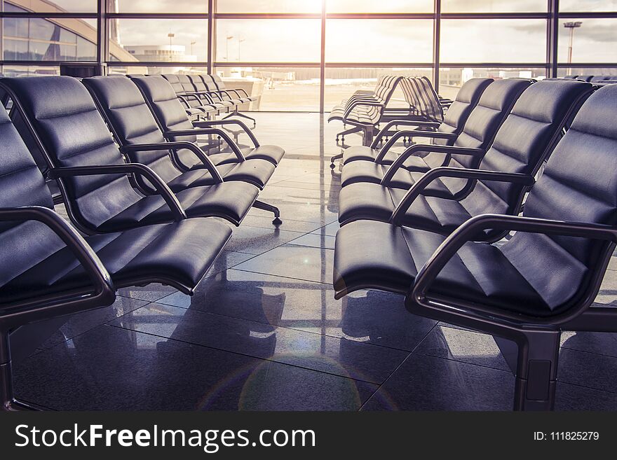 Seats In The Airport Waiting Room At Sunset. No One Is Sitting In The Airport.