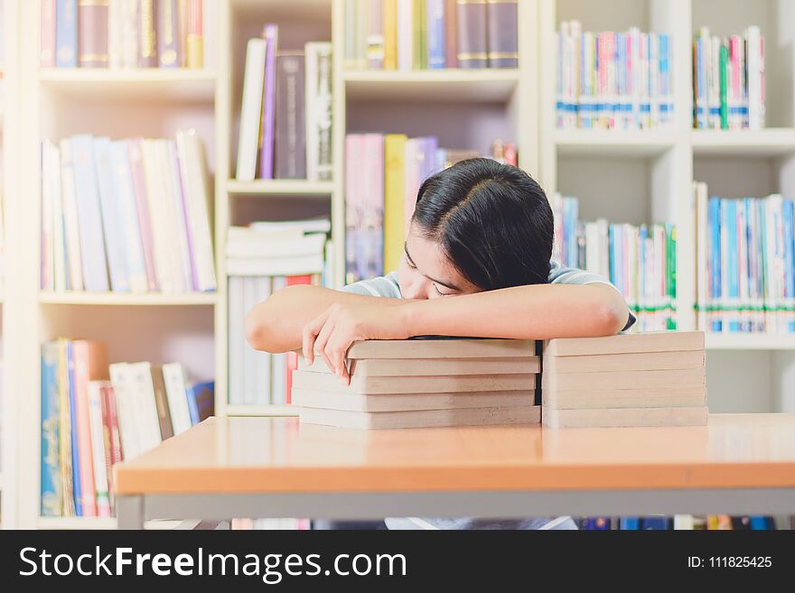 Portrait Of Clever Asian Student Exhausted For Reading