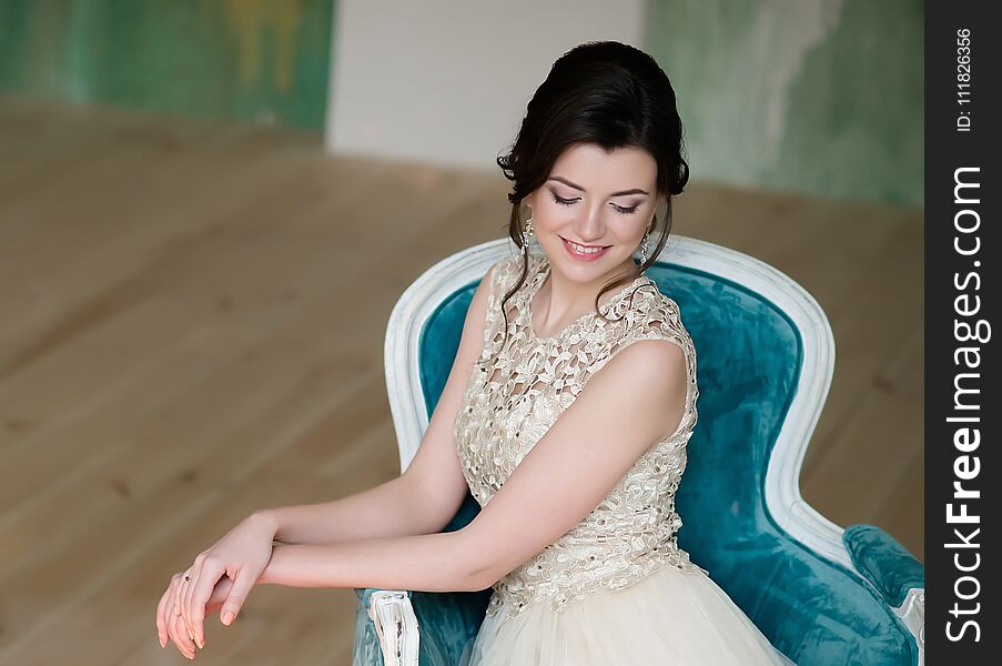 Half Length Portrait Of Brunette Smiling Woman Dressed In Sleeveless Light Evening Dress