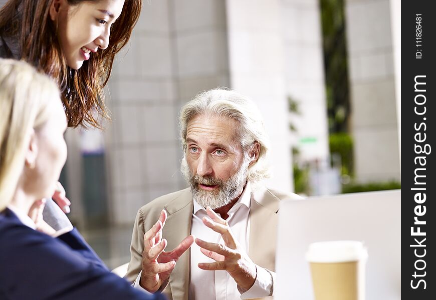 Multi-ethnic corporate people discussing business in office