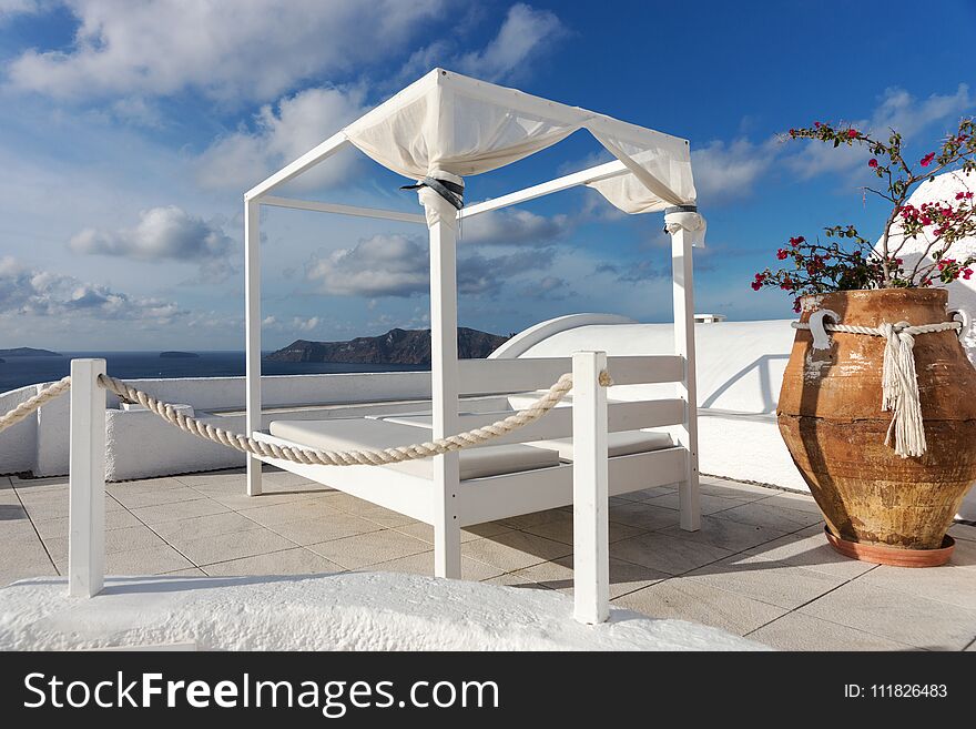 Relaxation zone on the terrace with sunbeds in Oia, Santorini