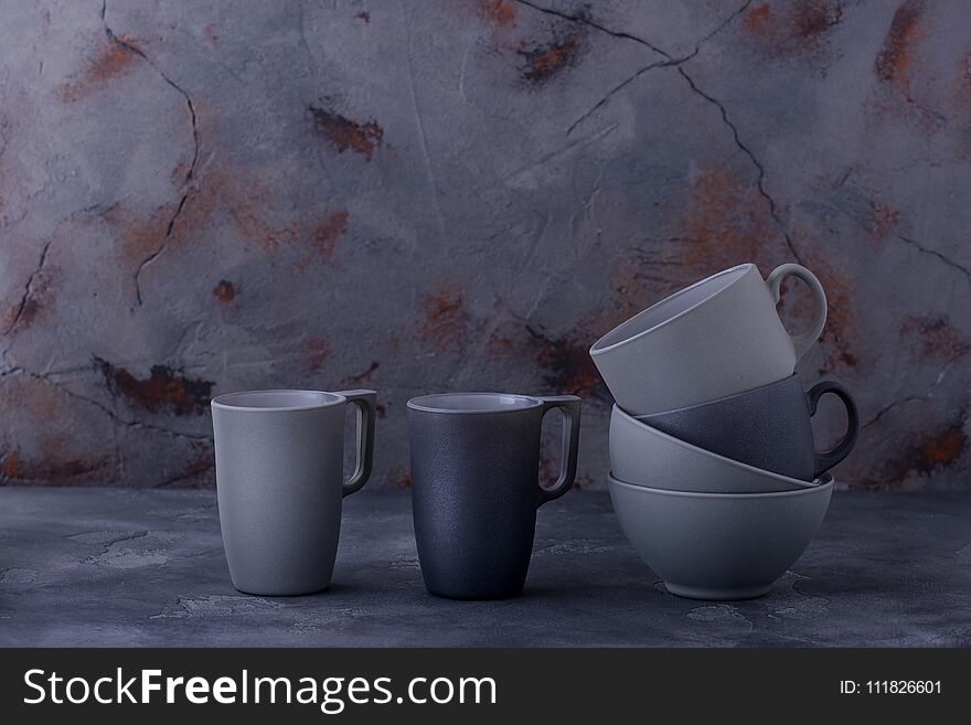 Bowls and cups on stone background. Copy space for text
