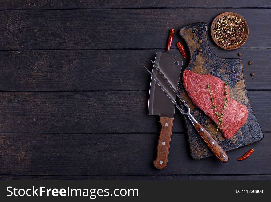 Raw beef steak and spice. Top view, copy space for your text