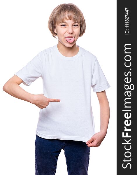 Little girl in blank t-shirt showing her tongue, isolated on white background. Portrait of happy teenager - design and people concept.