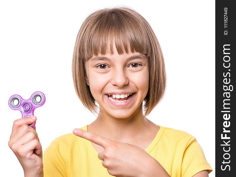 Young girl holding popular fidget spinner toy - close up portrait. Happy smiling child playing with Spinner, isolated on white background. Young girl holding popular fidget spinner toy - close up portrait. Happy smiling child playing with Spinner, isolated on white background.