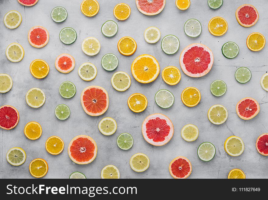 Summer background. Top view of sliced citrus fruit on light background. Flat lay. Summer background. Top view of sliced citrus fruit on light background. Flat lay