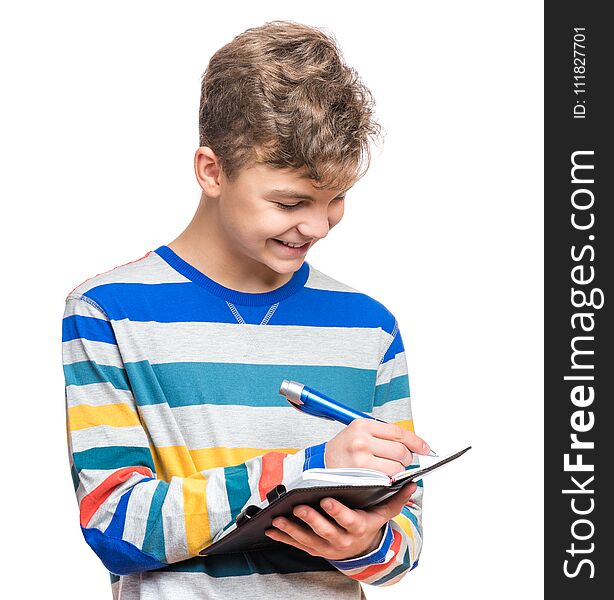 Portrait of caucasian smiling teen boy with notebook and blue pen writing something. Handsome funny teenager, isolated on white background. Happy student writing on note pad. Portrait of caucasian smiling teen boy with notebook and blue pen writing something. Handsome funny teenager, isolated on white background. Happy student writing on note pad.