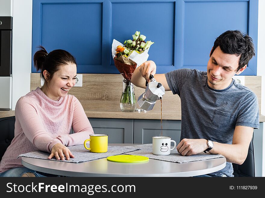 Cheerful beautiful young couple at home