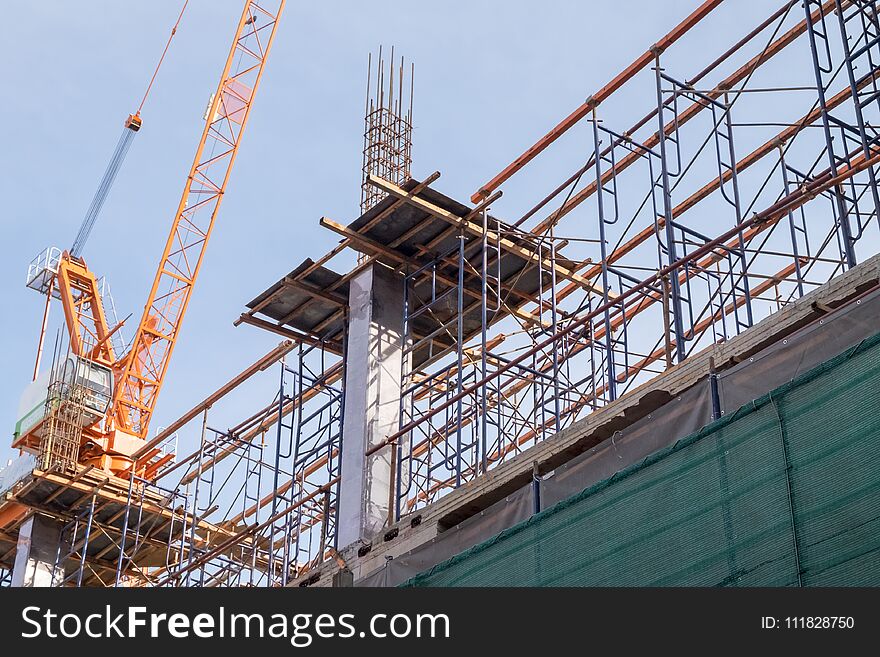 Construction site with steel and concrete pillars are molded into the structure of the building