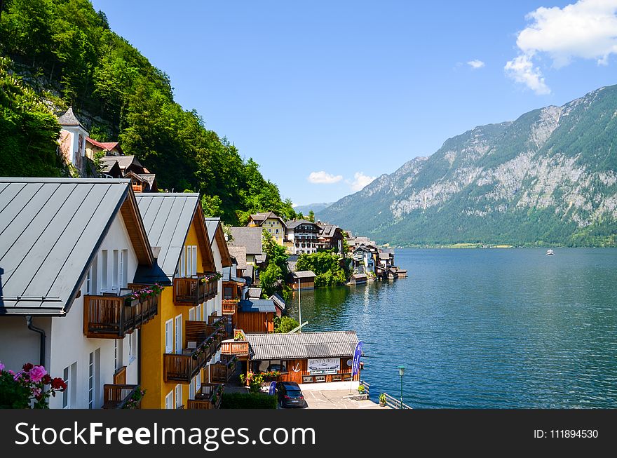 Photo Of Body of Water Beside Houses