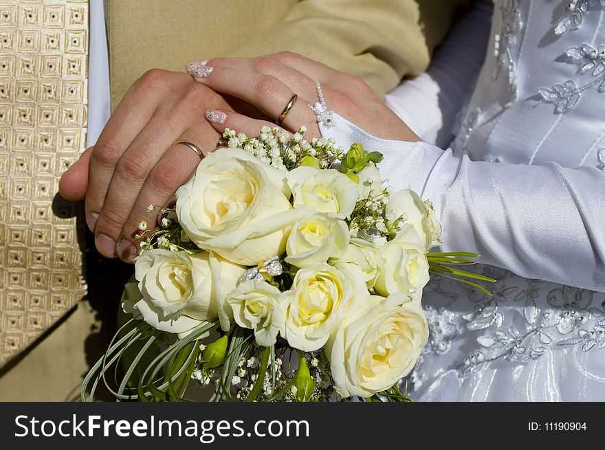 Wedding bouquet in the hands of the bride and groo