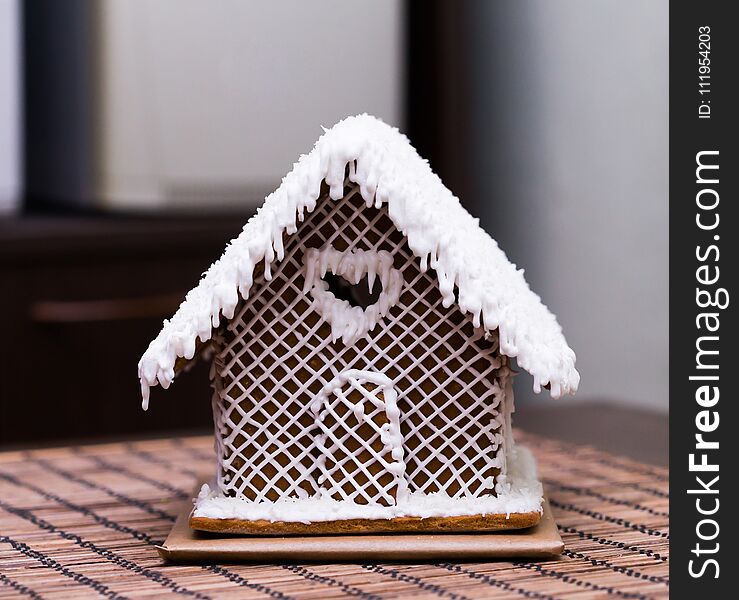 Beautiful appetizer sweet gingerbread house, white decoration. Christmas candy. Family home food. Winter background. Beautiful appetizer sweet gingerbread house, white decoration. Christmas candy. Family home food. Winter background.