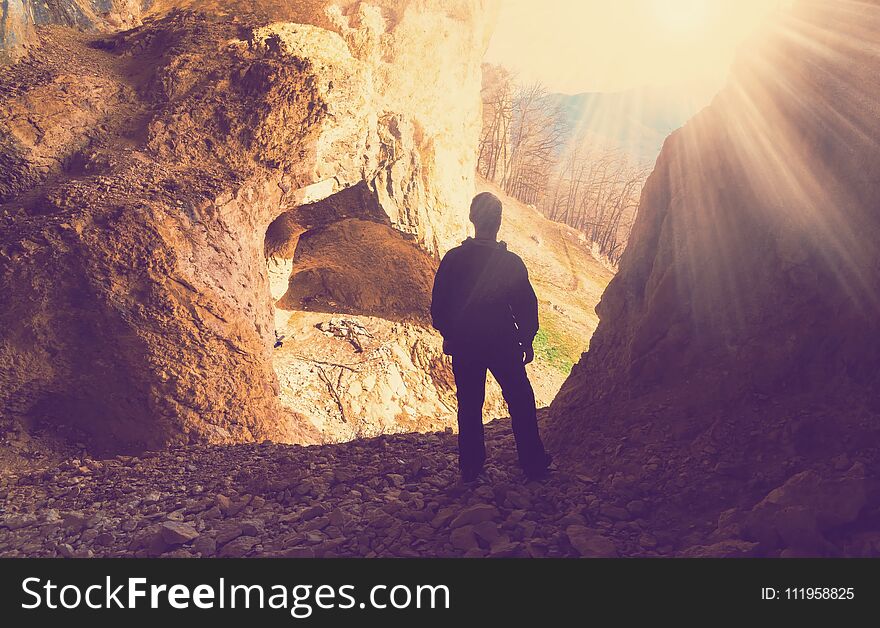 Beautiful man mainsail and cave mountains background. Beautiful man mainsail and cave mountains background