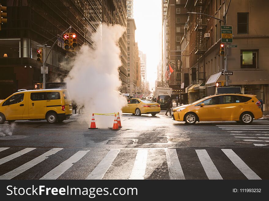 Manhattan morning sunrise view with yellow cabs passing in New York, United States