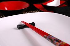 Red Chopsticks On White Plate Stock Photo