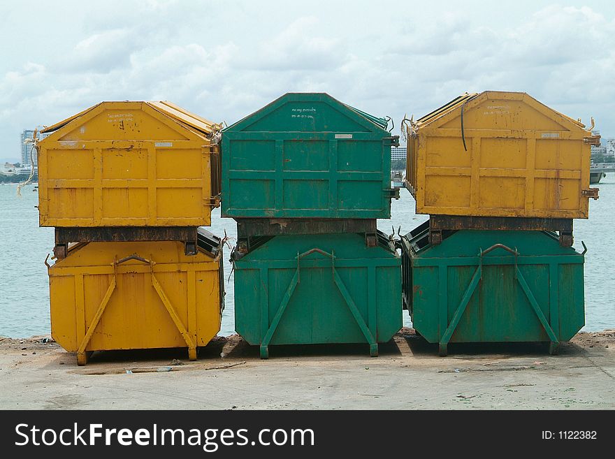 Six garbage containers, yellow and green