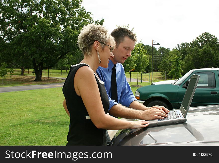 Business team working outdoors with laptop